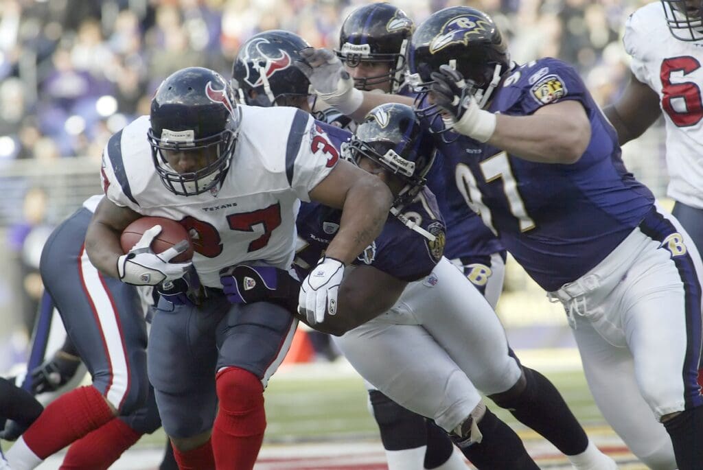 Dec 4, 2005; Baltimore, MD, USA; Houston Texans running back Domanick Davis (37) is tackled by Baltimore Ravens defenders Bart Scott (57) and Kelly Gregg (97) during 1st half action of the Texans matchup with the Ravens at M & T Bank Stadium. 