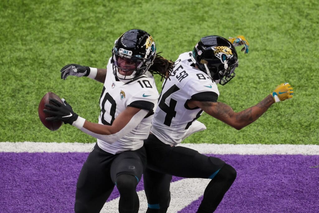 Dec 6, 2020; Minneapolis, Minnesota, USA; Jacksonville Jaguars wide receiver Laviska Shenault Jr. (10) celebrates his touchdown with wide receiver D.J. Chark (17) in the first quarter against the Minnesota Vikings at U.S. Bank Stadium.