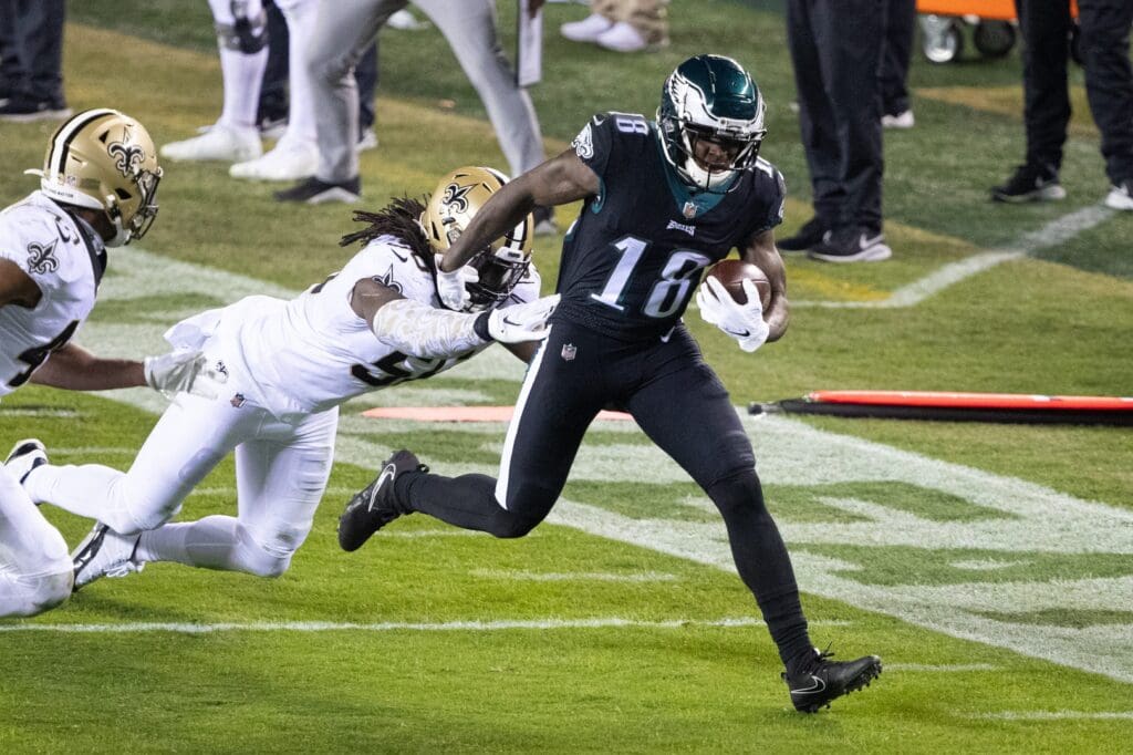 Dec 13, 2020; Philadelphia, Pennsylvania, USA; Philadelphia Eagles wide receiver Jalen Reagor (18) makes a reception past New Orleans Saints outside linebacker Demario Davis (56) during the fourth quarter at Lincoln Financial Field.
