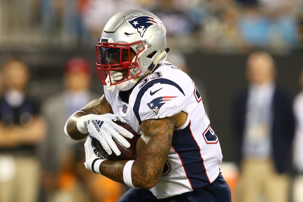 Aug 24, 2018; Charlotte, NC, USA; New England Patriots running back Jeremy Hill (33) runs the ball during the second quarter against the Carolina Panthers at Bank of America Stadium.