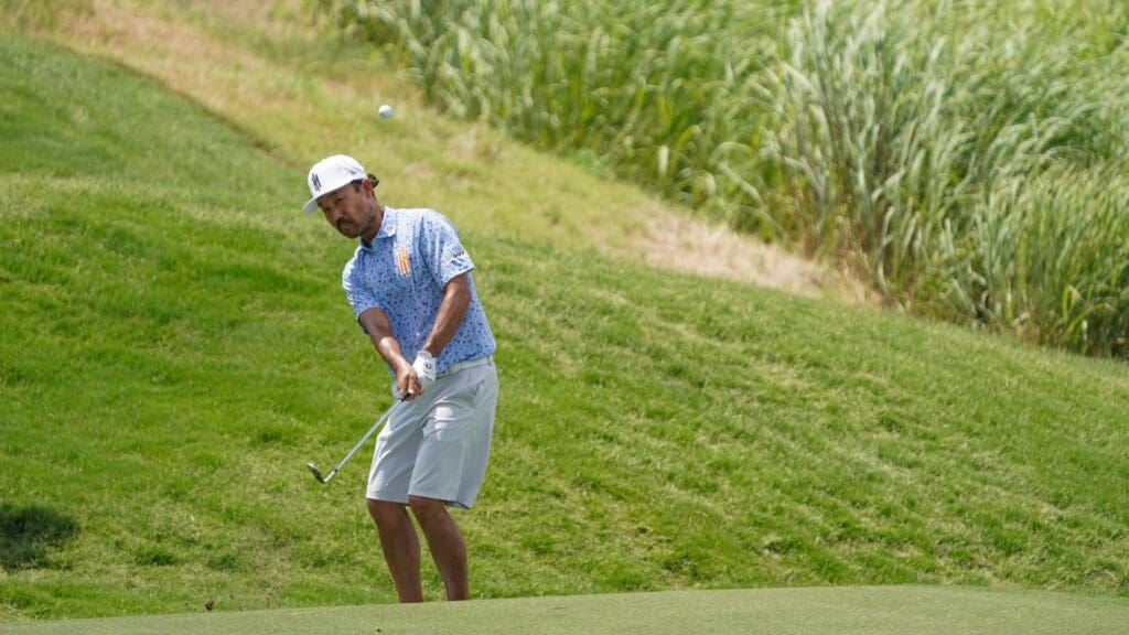 Jun 27, 2025; Carrollton, Texas, USA; Kevin Na chips on to the 15th green during the first round of the LIV Golf Dallas golf tournament at Maridoe Golf Club.