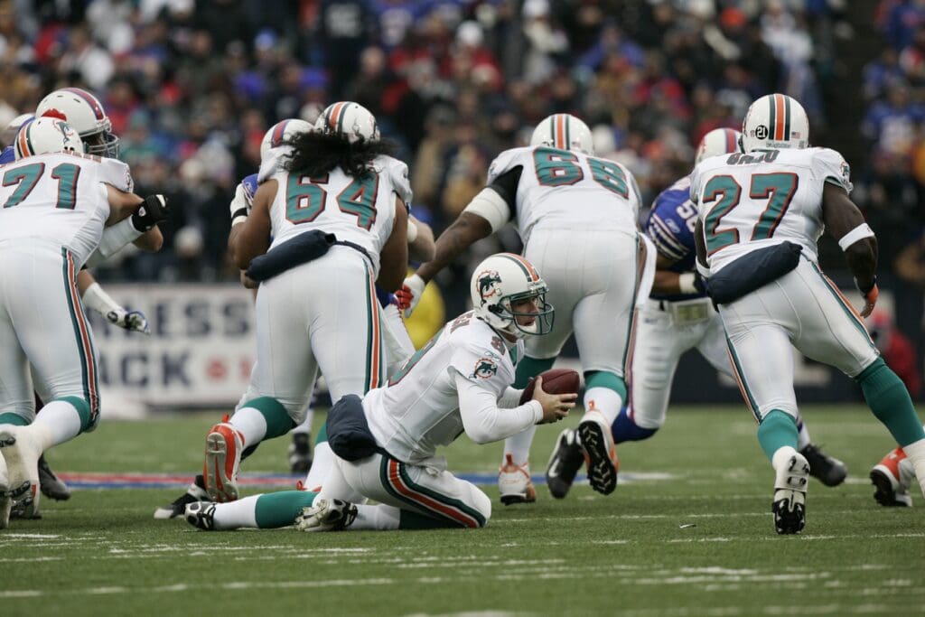 December 9, 2007; Orchard Park, NY, USA; Miami Dolphins quarterback (9) John Beck trips as he is about to hand-off during the first quarter of a game against the Buffalo Bills at Ralph Wilson Stadium. 