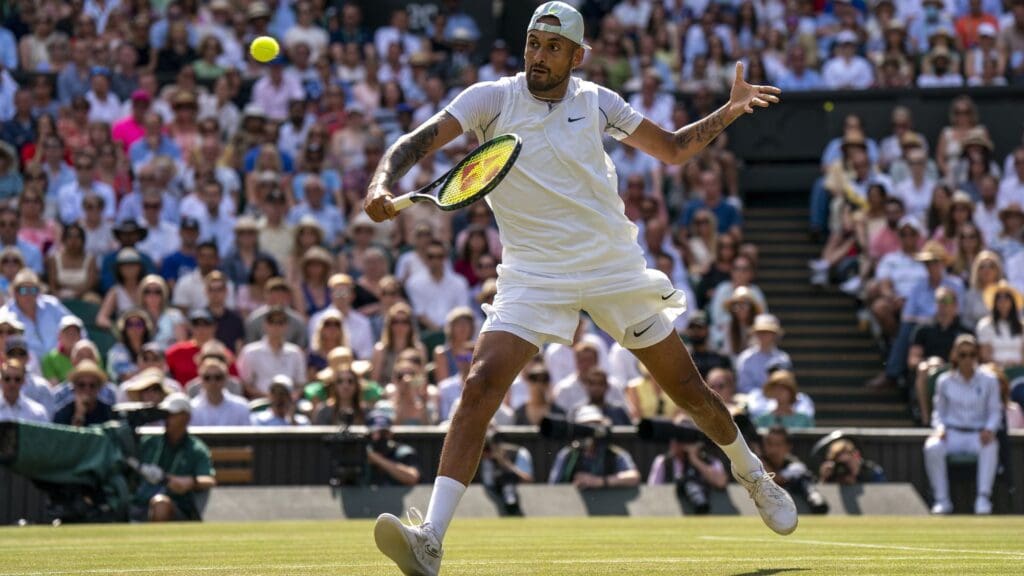 Jul 10, 2022; London, United Kingdom; Nick Kyrgios (AUS) returns a shot during the men s final against Novak Djokovic (not pictured) on day 14 at All England Lawn Tennis and Croquet Club. 