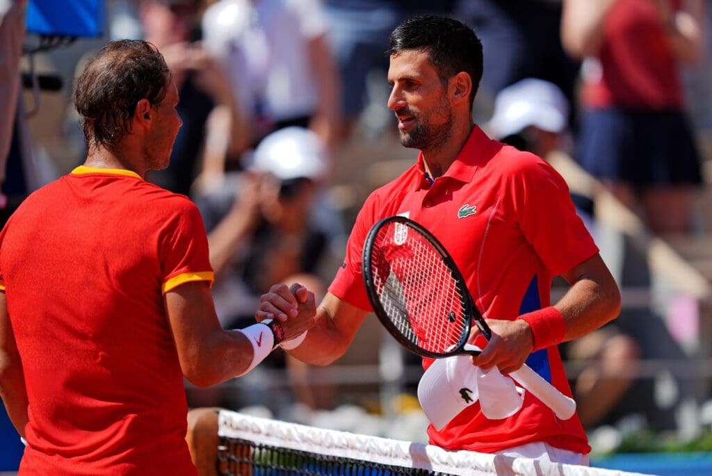 Jul 29, 2024; Paris, France; Novak Djokovic (SRB) shakes hands with Rafael Nadal (ESP) after their match in the men’s tennis sinlges first round during the Paris 2024 Olympic Summer Games at Stade Roland Garros.