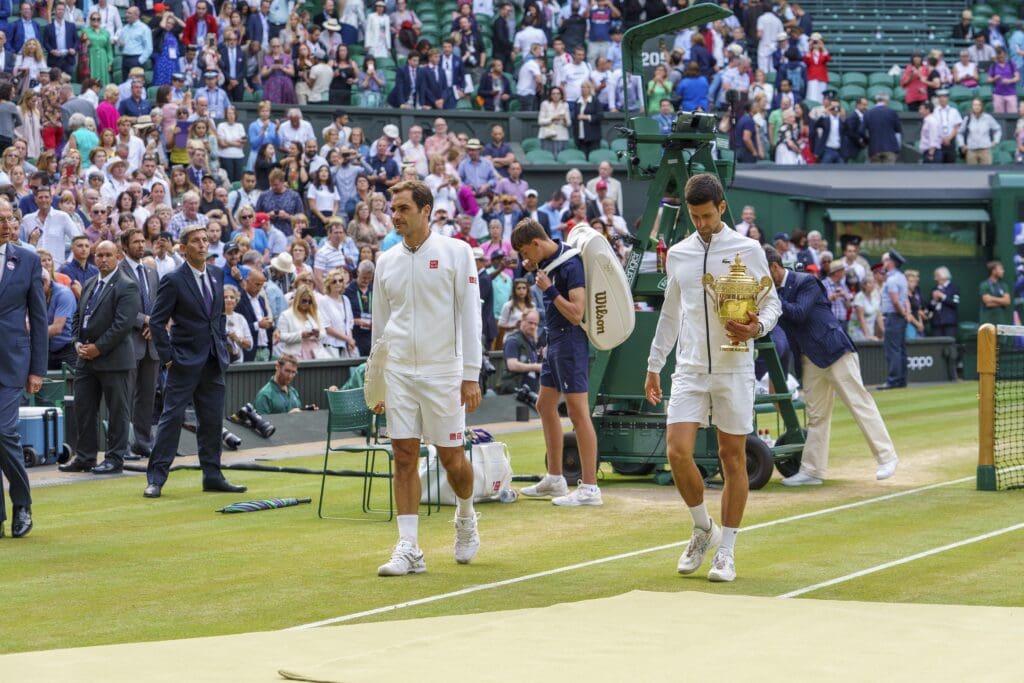 Jul 14, 2019; London, United Kingdom; Roger Federer (SUI) and Novak Djokovic (SRB) leave the court after the trophy presentation for the mens final on day 13 at the All England Lawn and Croquet Club.