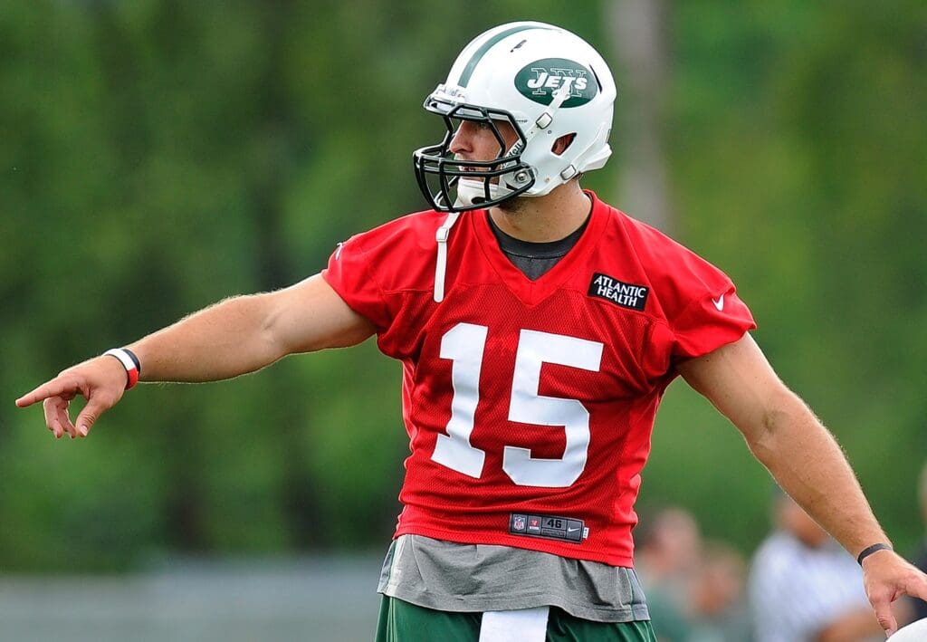 July 27, 2012; Cortland, NY, USA; New York Jets quarterback Tim Tebow (15) calls a play at the line during training camp at SUNY Cortland