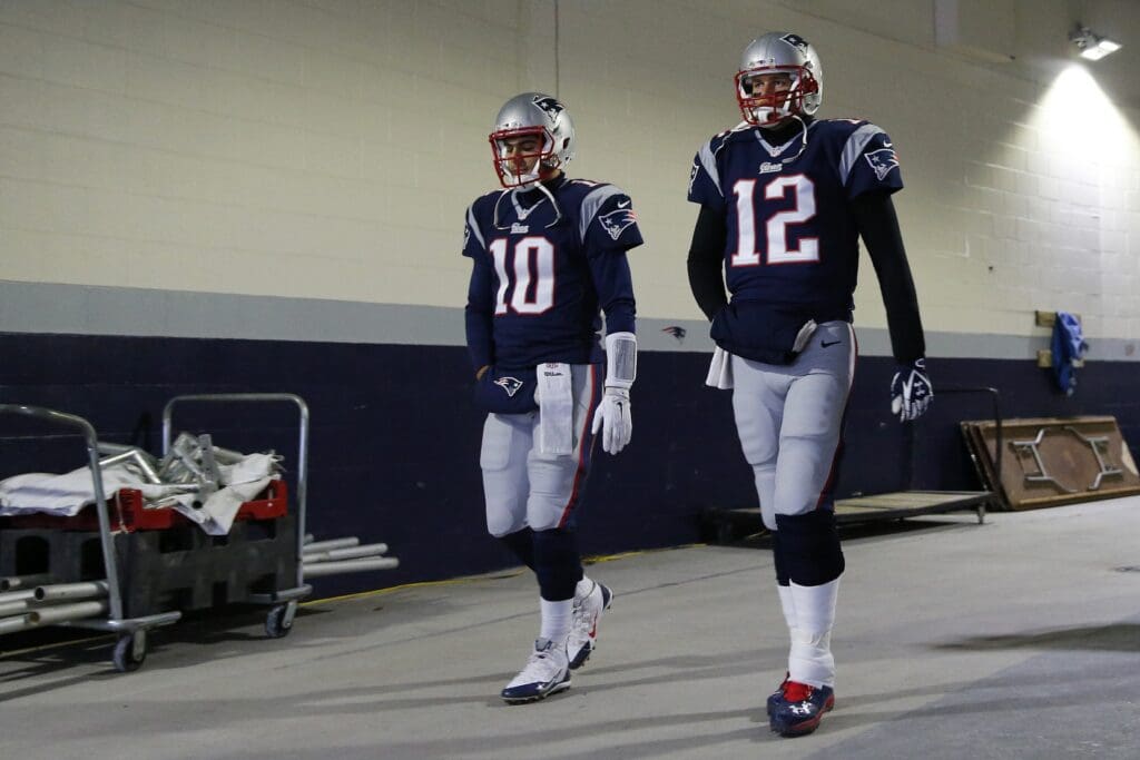 Jan 10, 2015; Foxborough, MA, USA; New England Patriots quarterback Tom Brady (12) and Patriots quarterback Jimmy Garoppolo (10) walk thru the tunnel prior to their 2014 AFC Divisional playoff football game against the Baltimore Ravens at Gillette Stadium. 