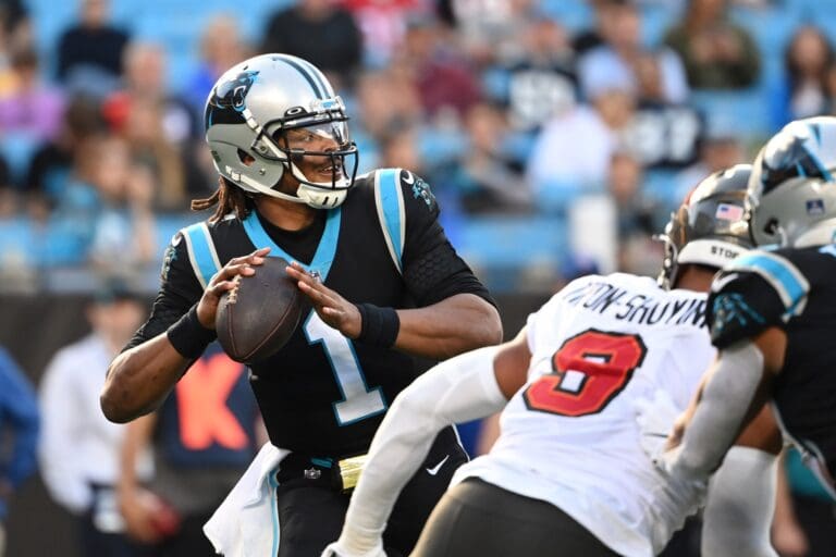 Dec 26, 2021; Charlotte, North Carolina, USA; Carolina Panthers quarterback Cam Newton (1) looks to pass as Tampa Bay Buccaneers outside linebacker Joe Tryon-Shoyinka (9) pressures in the third quarter at Bank of America Stadium. Mandatory Credit: Bob Donnan-USA TODAY Sports