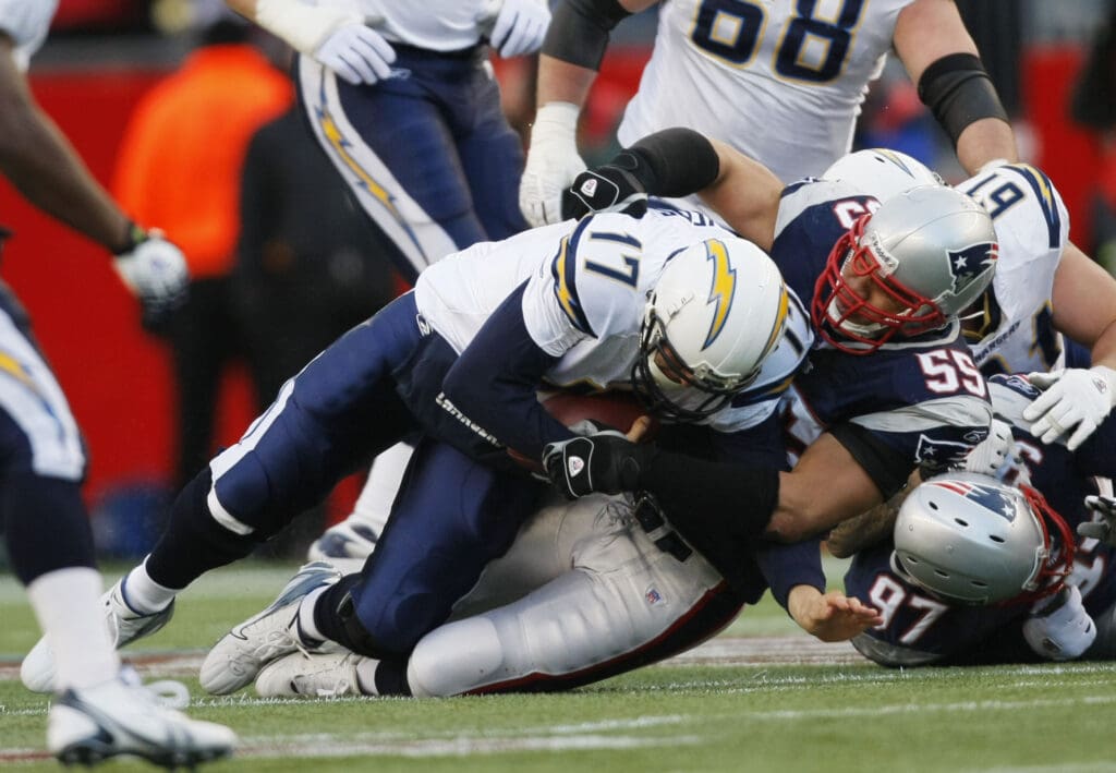 Jan 20, 2007; Foxborough, MA, USA; San Diego Chargers quarterback Philip Rivers (17) is sacked by New England Patriots linebacker Junior Seau (55) in the first quarter during the AFC Championship game at Gillette Stadium.  Mandatory Credit: David Butler II-USA TODAY Sports