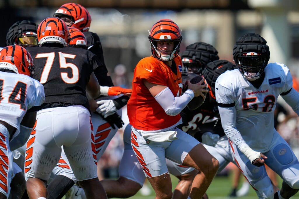 Cincinnati Bengals quarterback Joe Burrow (9) scrambles before being tapped be the defense during a preseason training camp practice in downtown Cincinnati on Wednesday, July 30, 2025.