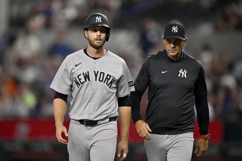 Aug 4, 2025; Arlington, Texas, USA; New York Yankees left fielder Austin Slater (29) walks off the field with manager Aaron Boone (17) during the first inning against the Texas Rangers at Globe Life Field. Mandatory Credit: Jerome Miron-Imagn Images