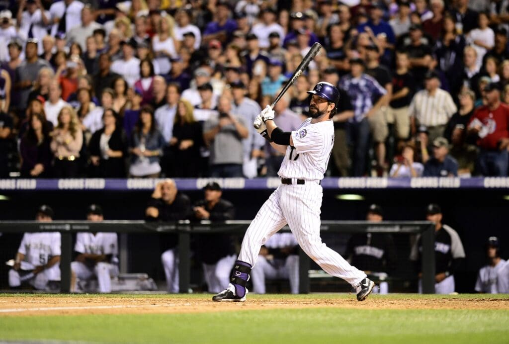 Sep 25, 2013; Denver, CO, USA; Colorado Rockies first baseman Todd Helton (17) hits a double in the fifth inning of the game against the Boston Red Sox at Coors Field. Mandatory Credit: Ron Chenoy-USA TODAY Sports