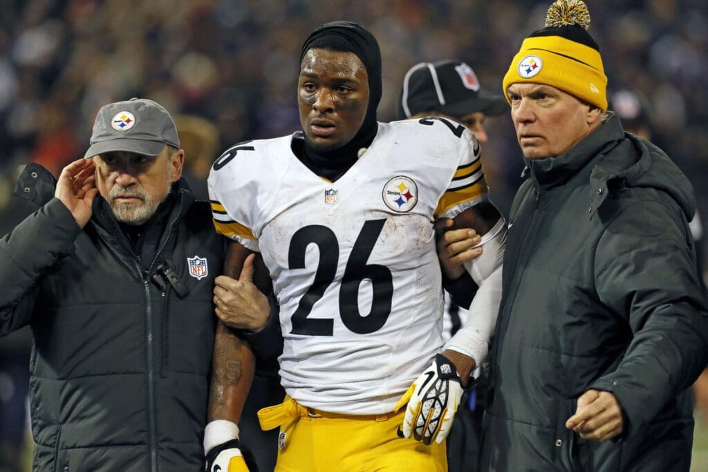 Nov 28, 2013; Baltimore, MD, USA; Pittsburgh Steelers running back LeVeon Bell (26) is led off the field by team staff after has his helmet was knocked off in the fourth quarter against the Baltimore Ravens during a NFL football game on Thanksgiving at M&T Bank Stadium. Mandatory Credit: Mitch Stringer-USA TODAY Sports